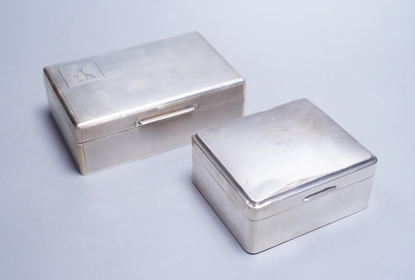 A late 1950's engine turned silver mounted rectangular cigarette box, by Mappin & Webb, 14cm and one other smaller silver mounted cigarette box.
